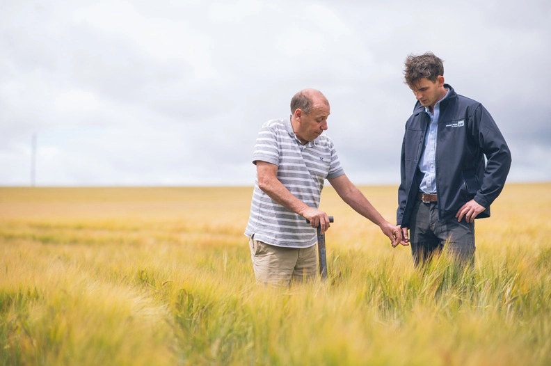 Wessex Water Catchment Management Adviser talking to a farmer in a field